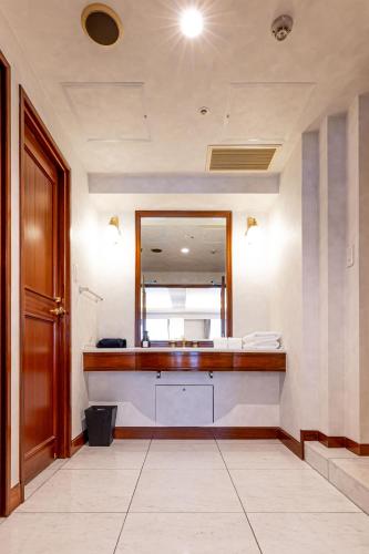 a bathroom with a vanity with a mirror and a sink at Prince Smart Inn Nagoya Sakae in Nagoya