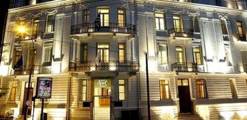 a large white building with windows and a street light at Art Hotel Athens in Athens