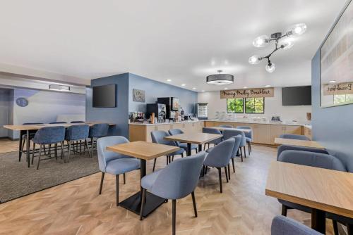 a waiting room with tables and chairs and a counter at Sleep Inn & Suites Merrillville in Merrillville