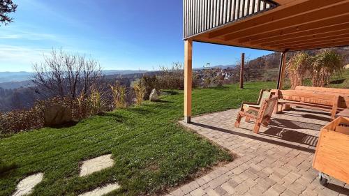 a wooden bench sitting under a pavilion on a lawn at Gartenwohnung mit Weitblick in Dienersdorf