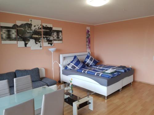 a bedroom with a bed and a couch and a table at B1006, Schönes und gemütliches Appartement in Lahnstein