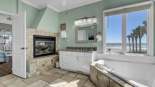 a bathroom with a tub and a sink and a window at 502 Ocean Blvd by AvantStay Beachfront w Pool Ocean Views in Mount Pleasant