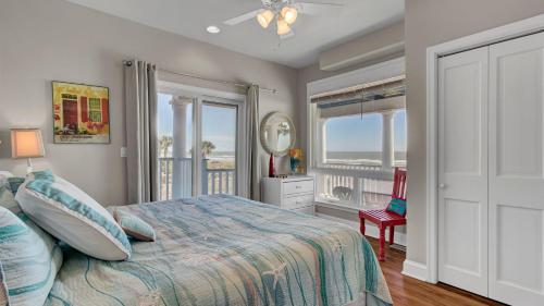 a bedroom with a bed and a view of the ocean at 502 Ocean Blvd by AvantStay Beachfront w Pool Ocean Views in Mount Pleasant