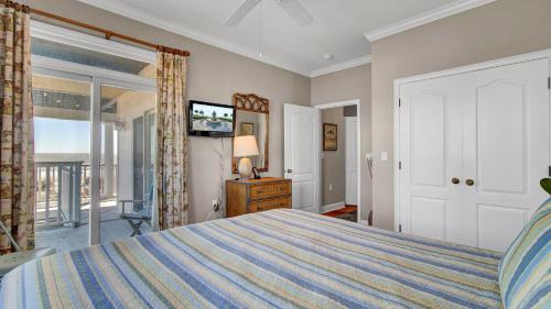 a bedroom with a large bed and a window at 502 Ocean Blvd by AvantStay Beachfront w Pool Ocean Views in Mount Pleasant