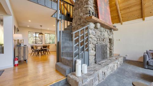 a large living room with a stone fireplace at Kenwood Vista by AvantStay 7acres w Pool Fire Pit Vineyard Views in Kenwood
