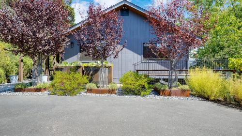 a house with trees in front of a driveway at Kenwood Vista by AvantStay 7acres w Pool Fire Pit Vineyard Views in Kenwood