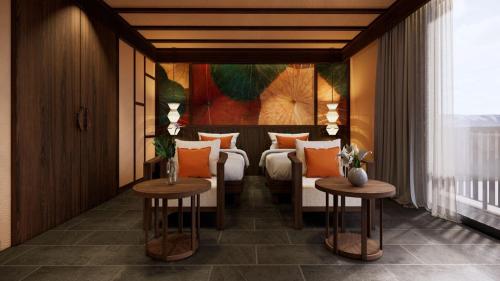 a hotel room with two beds and two tables at Amiana Resort Cam Ranh in Cam Ranh