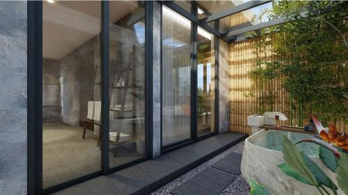 a glass door of a house with a pool at Amiana Resort Cam Ranh in Cam Ranh