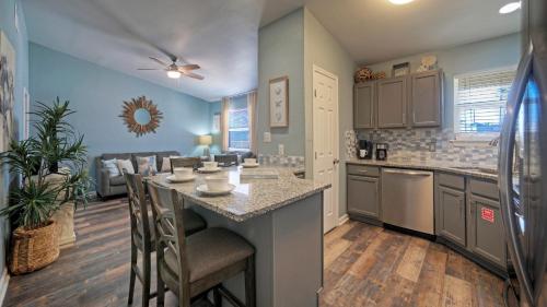 a kitchen with a large island in a room at Stylish 2BR Coastal Getaway w Pool Prime Location Lazy Fun in Port Aransas