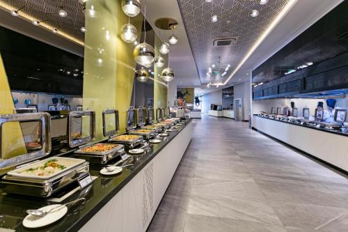 a buffet line with plates of food on display at Wind of Lara Hotel & SPA - All Inclusive in Lara
