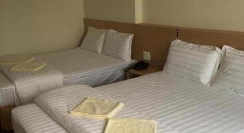 a hotel room with two beds with towels on them at Phuong Ly Ly in Ho Chi Minh City