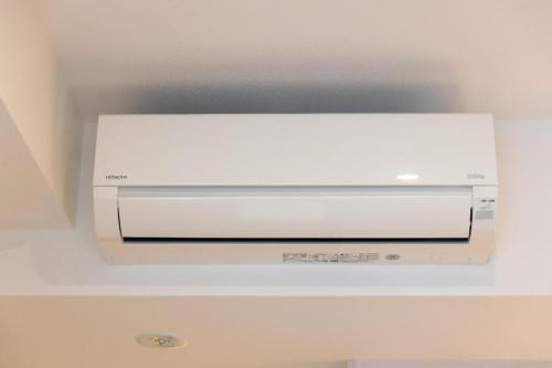 a white dvd player sitting on top of a ceiling at KEIKYU EX INN Tokyo Nihombashi in Tokyo