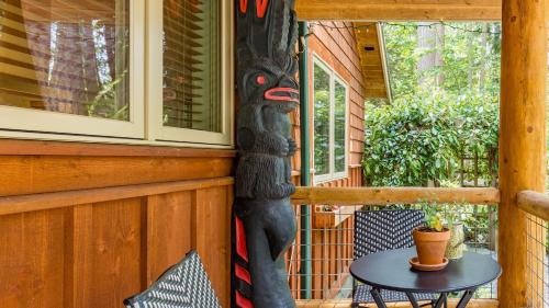 a statue of a bear on the side of a porch at The Cottage at Herons Roost by AvantStay in Langley