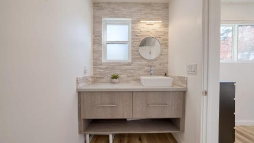 a bathroom with a sink and a mirror at Sunridge Lookout by AvantStay Big Backyard Oasis Patio Central Location in Del Monte Forest
