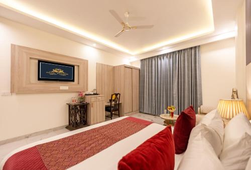 a hotel room with a bed and a couch at Hotel East End Delhi Aiport in New Delhi