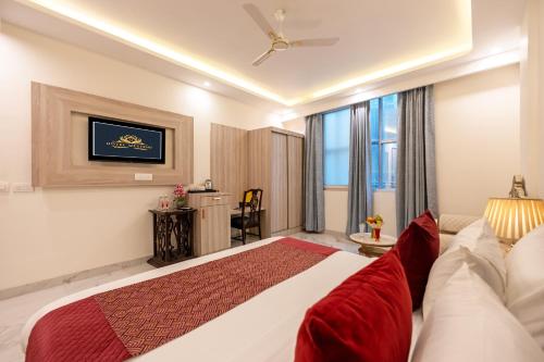 a hotel room with a bed and a couch at Hotel East End Delhi Aiport in New Delhi