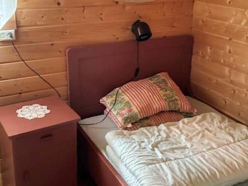 a small room with a bed and a night stand at 4 person holiday home in Eresfjord-By Traum in Øverås