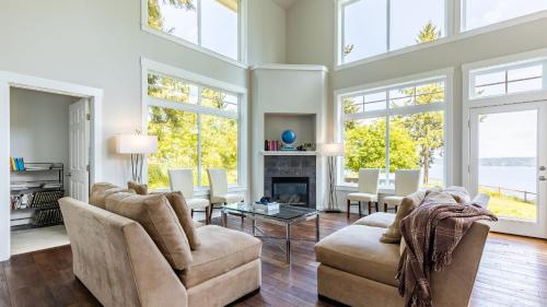 a living room with two chairs and a fireplace at Langley by the Sea by AvantStay Panoramic Vistas in Langley
