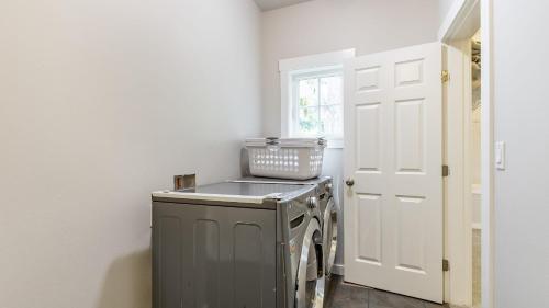a laundry room with a washer and dryer at Langley by the Sea by AvantStay Panoramic Vistas in Langley