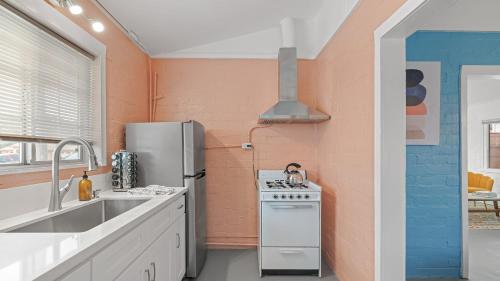 a kitchen with a refrigerator and a sink at Fable by AvantStay 2 Unique Spaces w Bowling Hot Tub Fire Pit Large Yard in Joshua Tree