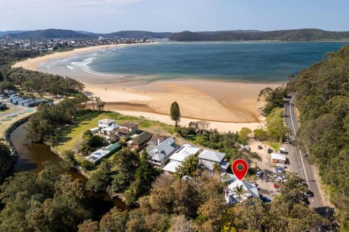 an aerial view of a beach with a house at Umina Beachside Getaway - Hot Tub - 5 Bedrooms in Umina