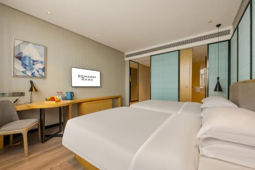 Cama o camas de una habitación en Echarm Hotel Jiangnan Wanda Baisha Avenue Branch