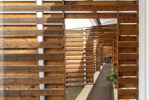 a wall of wood panels in a building at X Hotel in Saviano