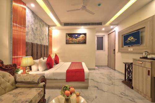 a hotel room with a bed and a couch at Hotel East End Delhi Aiport in New Delhi