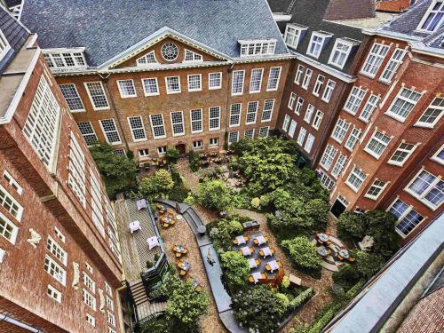 an overhead view of a building with a garden in front at Sofitel Legend The Grand Amsterdam in Amsterdam