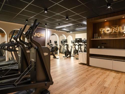 a gym with treadmills and exercise bikes in a room at Mercure Saint-Lary in Saint-Lary-Soulan