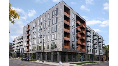 an apartment building on the corner of a street at CozySuites Marquee in Minneapolis