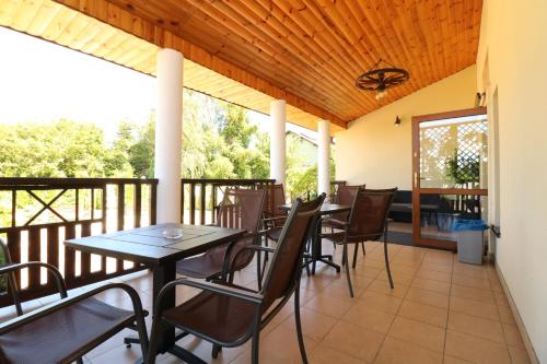 a patio with tables and chairs on a balcony at Pokoje Gościnne Anna Airport Modlin in Nowy Dwór Mazowiecki