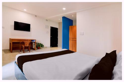 a bedroom with a bed and a desk with a television at Hotel Shreemahavia Home # Town Near Jagannath Temple and Sea Beach -Fully Air conditioned - Lift Wifi- And Parking Facilities -Excellent Customer Service Awarded -Best Seller in Puri