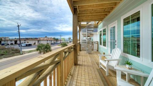 a porch with a bench and a view of a street at Casa Rita by AvantStay Snowbird Discounted Rates Private Pool Near Beach in Port Aransas