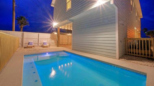 a swimming pool in front of a house at night at Casa Rita by AvantStay Snowbird Discounted Rates Private Pool Near Beach in Port Aransas