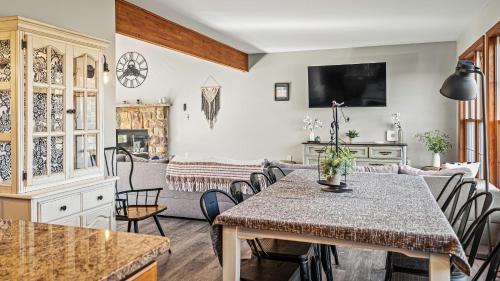 a living room with a table and a couch at Lakers Pointe by AvantStay Lakefront Private Peninsula Hot Tub Game Room in Long Pond