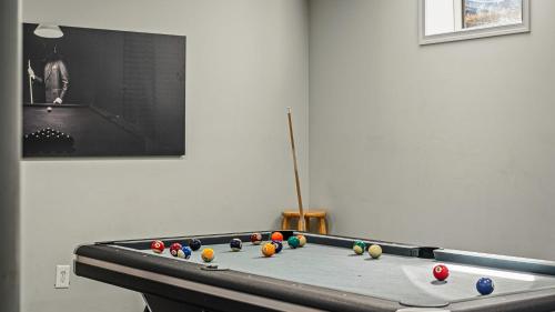 a pool table with balls on it in a room at Lakers Pointe by AvantStay Lakefront Private Peninsula Hot Tub Game Room in Long Pond