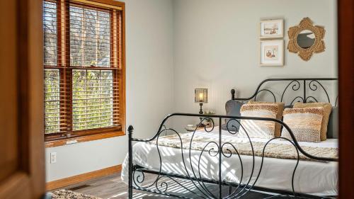 a bedroom with a bed and a window at Lakers Pointe by AvantStay Lakefront Private Peninsula Hot Tub Game Room in Long Pond