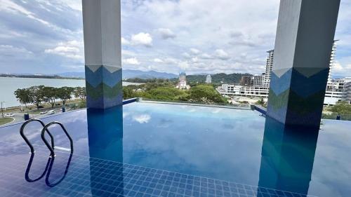 a swimming pool with a view of the water at MC homes in Kota Kinabalu