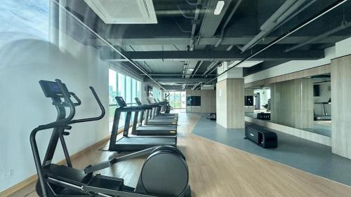 a gym with a row of tread machines in a room at MC homes in Kota Kinabalu