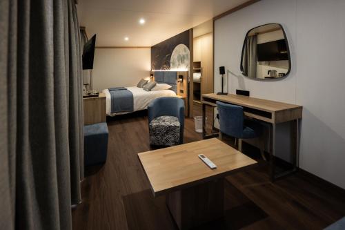 a hotel room with a bed and a desk at In Secreto in Dunières