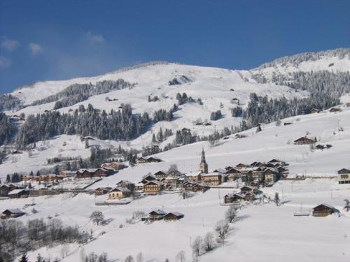 a small village in the snow with a mountain at Appartement T2 Hauteluce, 4 pers., piscine, parking, WiFi - FR-1-342-322 in Hauteluce