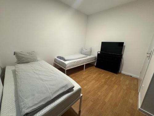 a small room with a bed and a desk at Apartment Mühlentor Am Wariner See in Warin