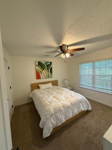 a bedroom with a bed and a ceiling fan at Modern 1- Queen Bed On Quiet Block in Hephzibah