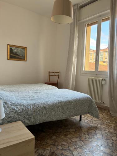 a bedroom with a bed and a window at Alfano Apartment in Bologna