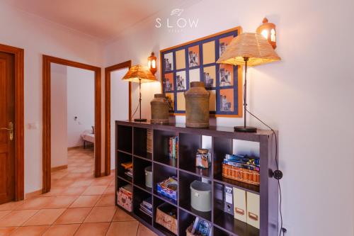 a book shelf with a lamp on top of it at Villa Ewa by Slow Villas in Cala Pi