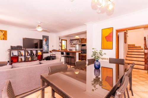 a living room with a couch and a table at Villa Ewa by Slow Villas in Cala Pi