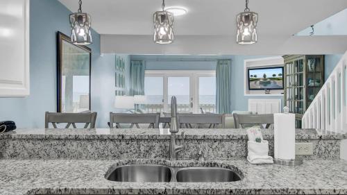 a kitchen with a sink and a counter top at 11E Mariners Walk by AvantStay Ocean Views Beachfront Living Shared Pool in Isle of Palms