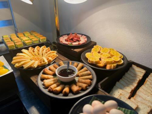 a buffet of different types of food on a table at Dawn Boutique Luangprabang Hotel in Luang Prabang