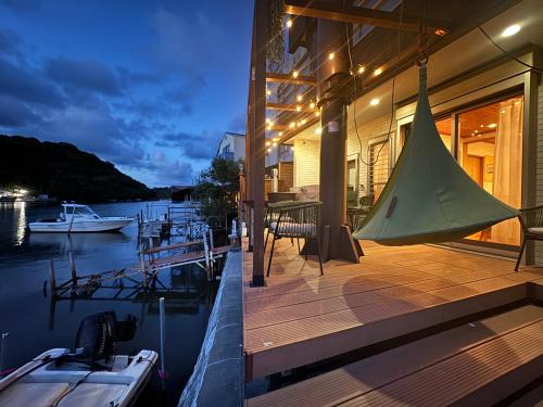 a house on the water with a boat on the dock at UMI&kanzanji in Hamamatsu
